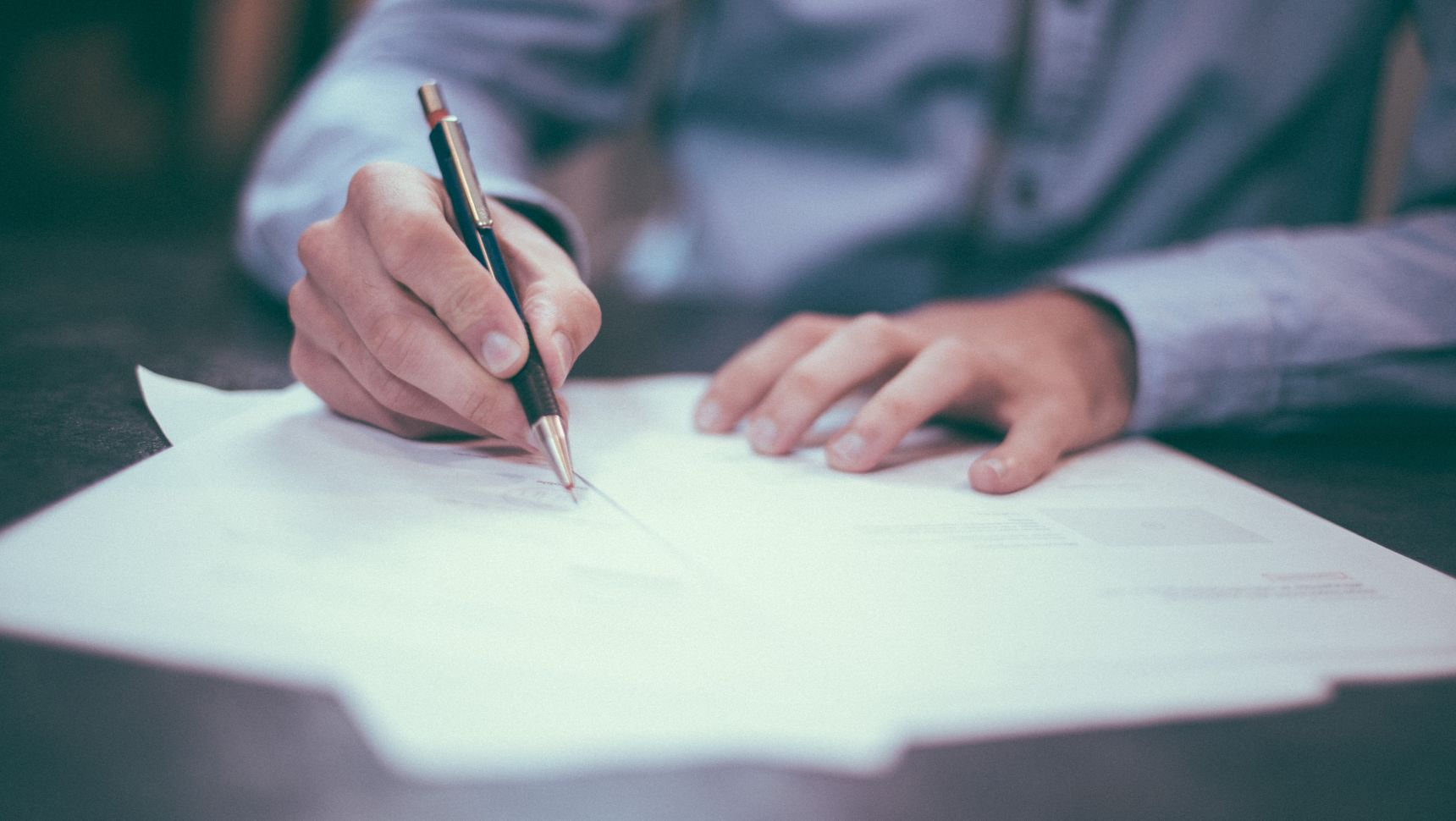 person filling out paperwork